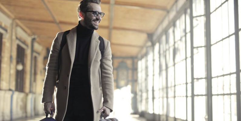 Business Trip - Man in Brown Robe Carrying Bag Smiling