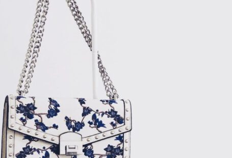 Handbags - White and Blue Floral Flap Sling Bag Hanging on White Steel Rack