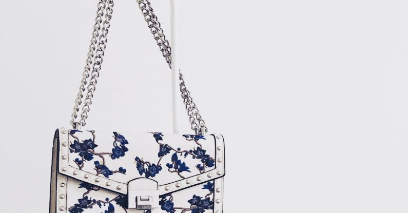 Handbags - White and Blue Floral Flap Sling Bag Hanging on White Steel Rack