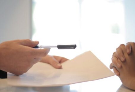 Negotiation - Crop businessman giving contract to woman to sign