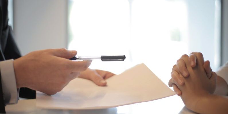 Negotiation - Crop businessman giving contract to woman to sign