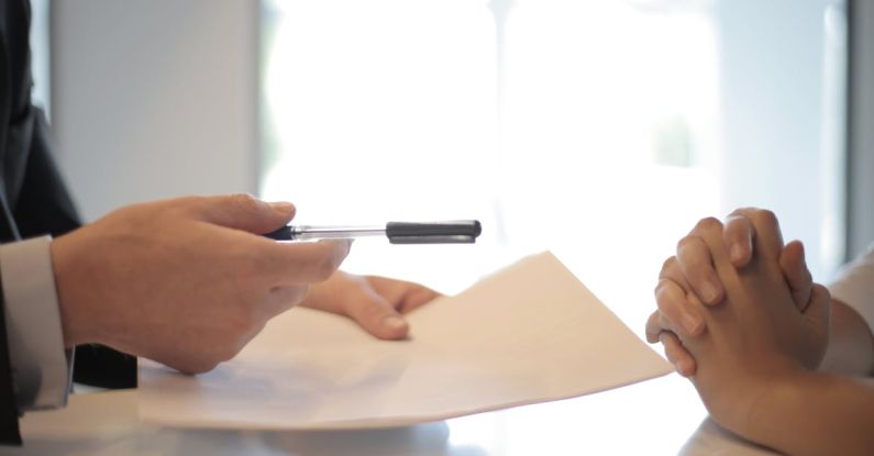 Negotiation - Crop businessman giving contract to woman to sign