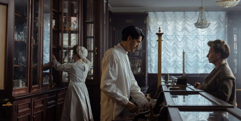 Buying Vintage - Man in White Laboratory Coat Standing in Front of an Elderly Woman