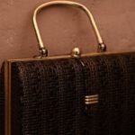 Vintage Trend - Vintage bag with golden handle placed on reflecting surface as accessory for garment