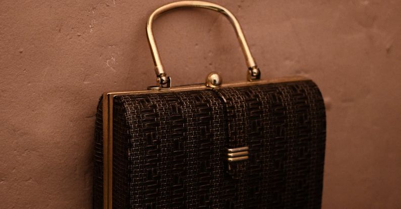 Vintage Trend - Vintage bag with golden handle placed on reflecting surface as accessory for garment