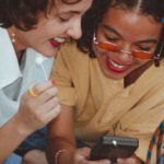 Vintage Fashion - Shallow Focus Photo of Woman Using Game boy