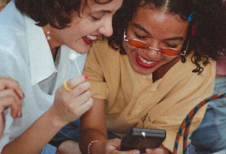 Vintage Fashion - Shallow Focus Photo of Woman Using Game boy