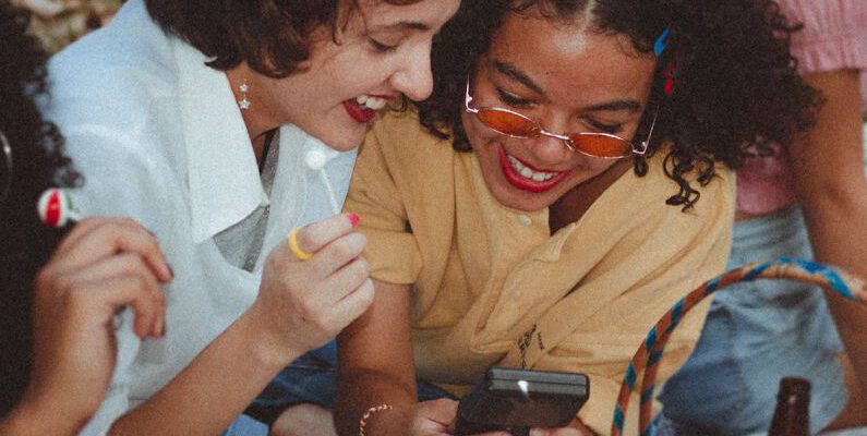 Vintage Fashion - Shallow Focus Photo of Woman Using Game boy