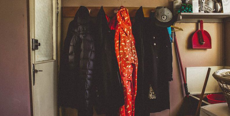 Coats - Hanged Black and Orange Coats Inside Room