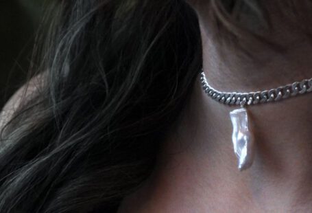 Jewelry - A Woman Wearing Silver Necklace