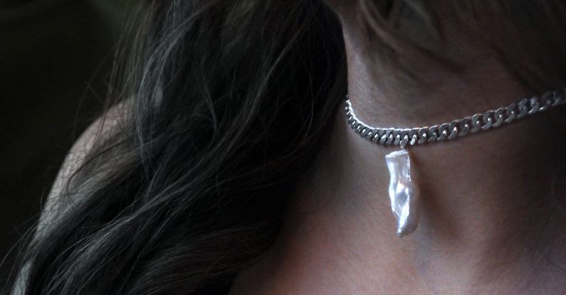 Jewelry - A Woman Wearing Silver Necklace