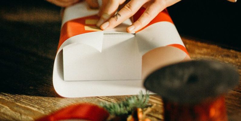 Gift Wrapping - Person Wrapping White Box