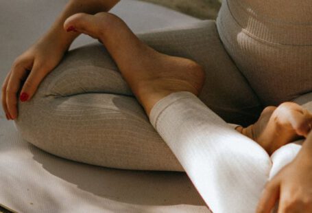 Activewear - A Woman in Activewear Sitting on a Yoga Mat